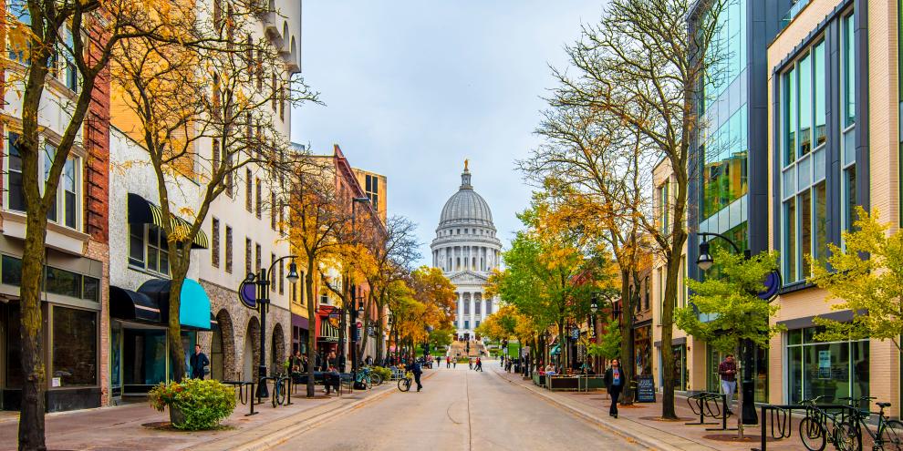 Die Innenstadt von Madison, der Hauptstadt von Wisconcin, USA. Zu sehen ist eine autofreie Straße mit Blick auf das Capitol. 