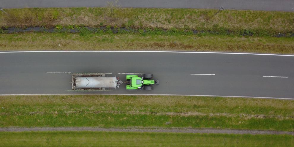 Transport von Gülle mit einem Traktor und Güllefass aus der Vogelperspektive