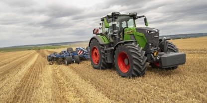 Ein Fendt-Vario-Traktor der neuesten Generation mit einem Grubber fährt auf einem Acker.